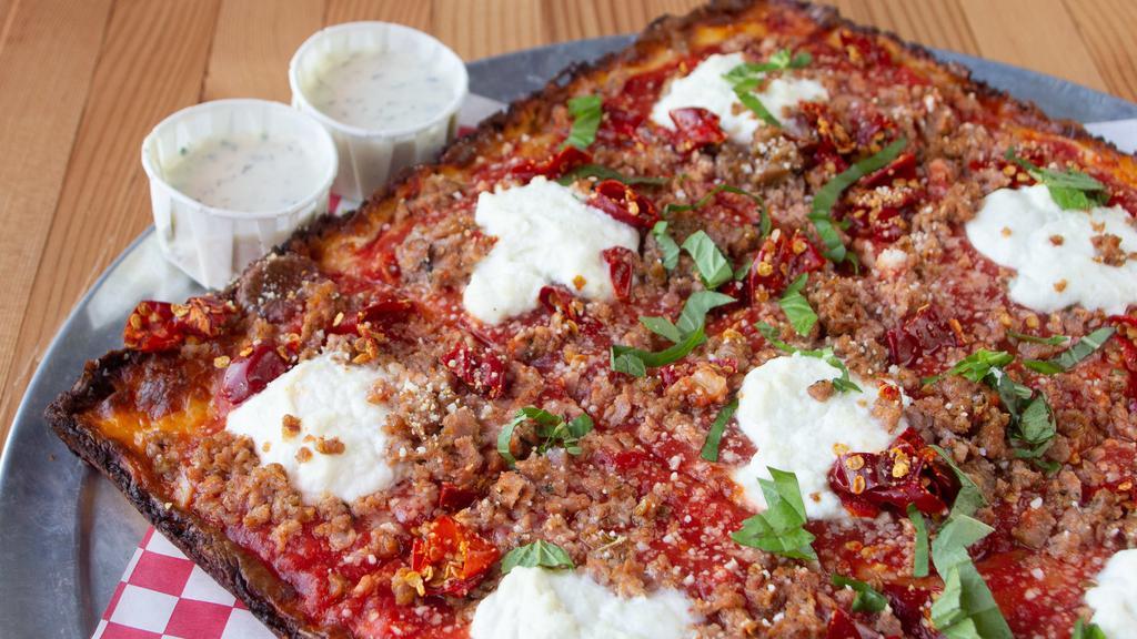 The 4 Pizza (Whole) · Sausage, ricotta, calabrian chilies, aged mozzarella, red sauce, pecorino romano, and basil. Comes with two sides of ranch.