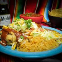Pollo Rico · Chicken chimichanga smothered with our delicious red or green sauce, topped with guacamole, ...