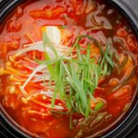 Kimchi Jjigae (Kimchi Stew) · A spicy, hearty kimchi stew with pork, tofu, enoki-mushrooms and scallions. Served with side...