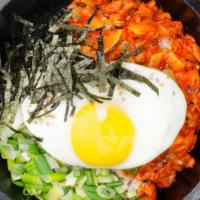 Kimchi Dolsot · Fried kimchi and rice served in a hot stone bowl cooked to a golden crispy crust. Served wit...