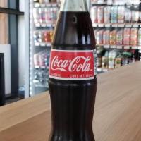 Coca Cola · Made with cane sugar!