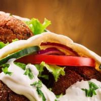 Falafel · Garbanzo beans, parsley, cilantro, onions, garlic, and spices, deep fried and served on pita...