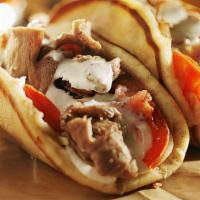 Classic Gyro · Lamb and beef with spices, served on pita bread with lettuce, tomatoes, onions, and tzatziki...