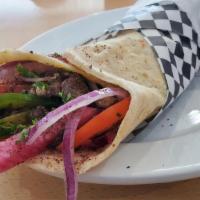 Beef Shawarma Wrap · Grilled beef slices ,hummus , tahini sauce ,onions, bill pepper ,pickles, pickled turnips, r...