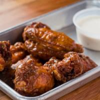 Bone-In Wings · Eight bone-in wings tossed with buffalo, hot, habanero BBQ or honey garlic. Served with a si...