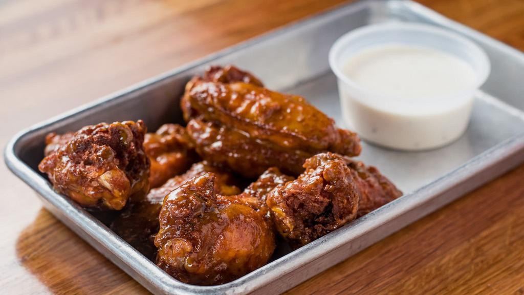 Bone-In Wings · Eight bone-in wings tossed with buffalo, hot, habanero BBQ or honey garlic. Served with a side of ranch or blue cheese.