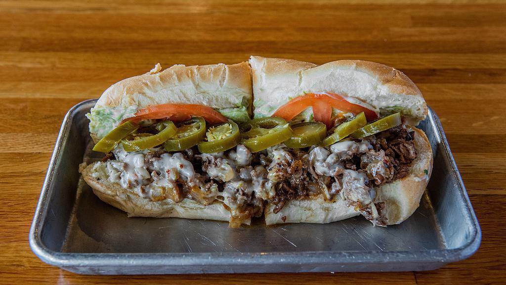 Psycho Cheesesteak · Spicy. Fan-favorite. Sirloin, grilled onions, jalapeños, avocado, cilantro mayo, tomatoes and Pepper Jack cheese.