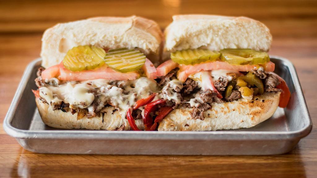Hannibal Cheesesteak · Spicy. Fan-favorite. Sirloin, grilled onions, hot cherry peppers, sweet peppers, tomatoes, pickles and white American cheese.