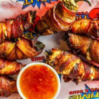 Stuffed Jalapeños · Fresh jalapeños, stuffed with cream cheese and wrapped in bacon.