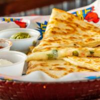 Quesadillas · A flour tortilla stuffed with cheese and pico de gallo. griddled to a golden brown and serve...