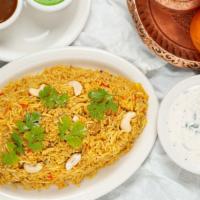 Chicken Biryani · Boneless chicken cooked in basmati rice with cashew, cilantro, herbs and spices. Served with...