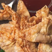 Fried Wontons · Stuffed with flavorful ground pork, these crispy-fried wontons are served with sweet plum sa...