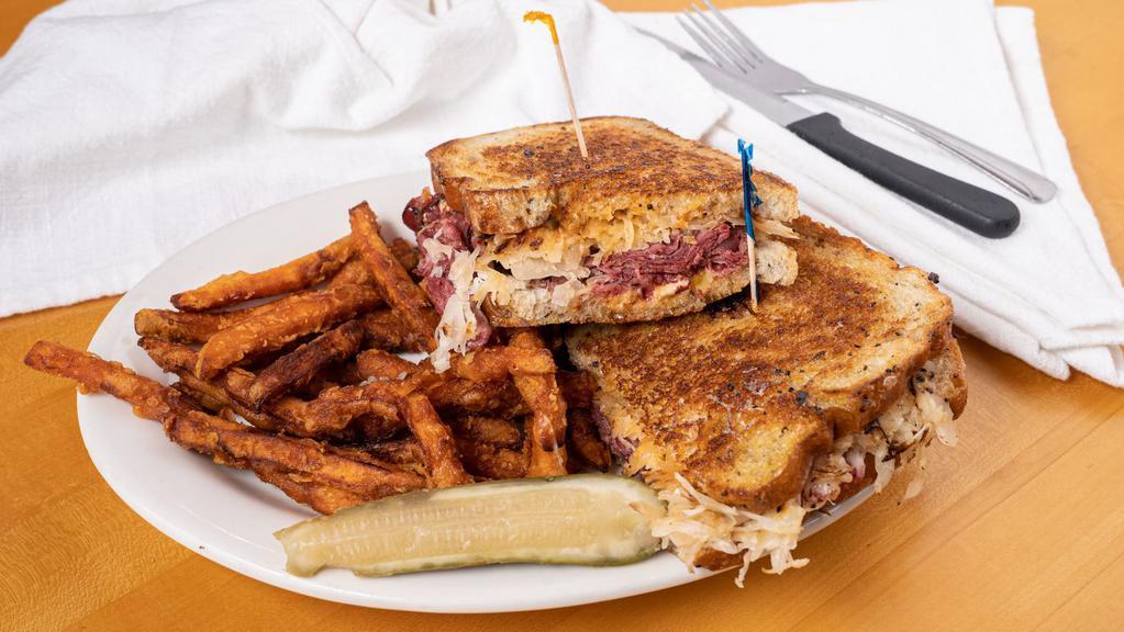 Famous Reuben · House cured corned beef, our mustard seed and caraway rye bread, pub made sauerkraut, our 1000 island dressing and swiss cheese. 
Served with Oregon Kettle chips and a pub spicy pickle