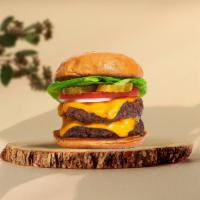 Double The Bite Vegan Burger · Two seasoned plant-based patties topped with melted vegan cheese, lettuce, tomato, onion, an...