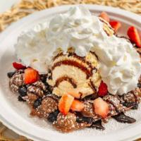 What The Fudge · Chocolate egg puff, vanilla ice cream, powdered sugar, strawberry, chocolate drizzle and whi...