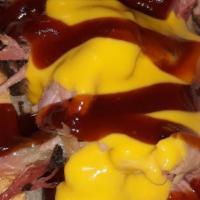 Pull Pork Hotlink · Our smoked hotlink in a hotdog bun, topped with smoked pull pork and nacho cheese, and a dri...