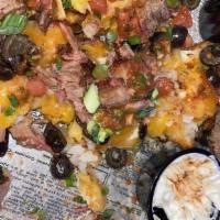 Nachos Or Tatchos · Choice of tortilla chips or tater tots topped with shredded and nacho cheese, diced tomato, ...