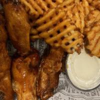 Traditional Wings · Eight wings served with fries. Choice of sauce and side of ranch or bleu cheese.