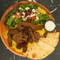 Gyros Plate · Layers of select beef and lamb, perfectly seasoned with zesty spices; broiled on a vertical ...