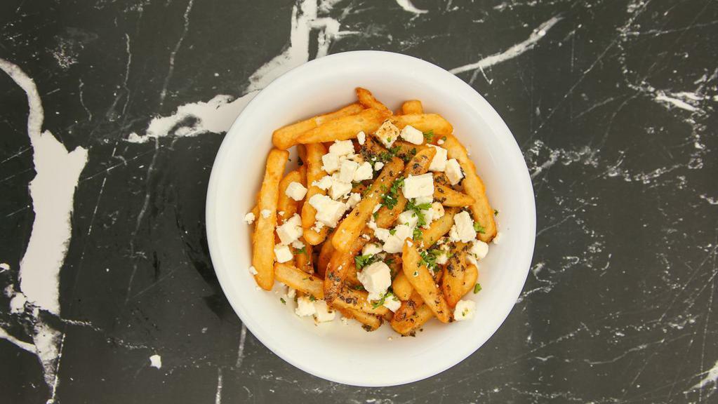 Feta Fries · Our crispy fries topped with feta cheese, and homemade Dressing sauce. They are simply irresistible.