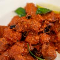 Chicken 65 · Fried boneless chicken sauteed with green chilies, ginger, garlic & onions.