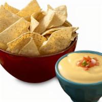Queso + Chips · Crispy tortilla chips served with gooey, cheesy, queso!