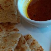 Roti Canal · Spicy. 
Malaysian pancake accompanied with our homemade spicy curry dip.