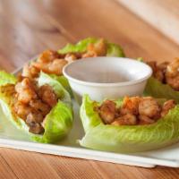 Lettuce Wraps · Tossed with seared water chestnuts & sweet onions.  Served with soy mustard sauce.