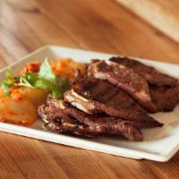 Kalbi · Korean BBQ Beef Short Ribs. Served with Jasmine Rice & Housemade Kimchi