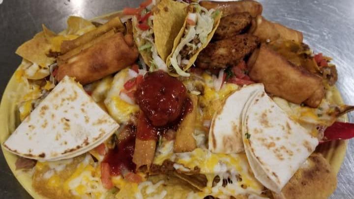 Botanas Varias · An exciting sample of our delicious appetizers: mini tacos, cheese quesadillas, chipotle chicken wings, mini chimichangas, taquito bites, jalapeño poppers, on a bed of nachos. Serves two-four amigos who can't make up their mind.