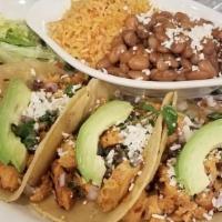 Street Tacos · Three corn tortillas with your choice of chicken or carnitas served street-style with red on...