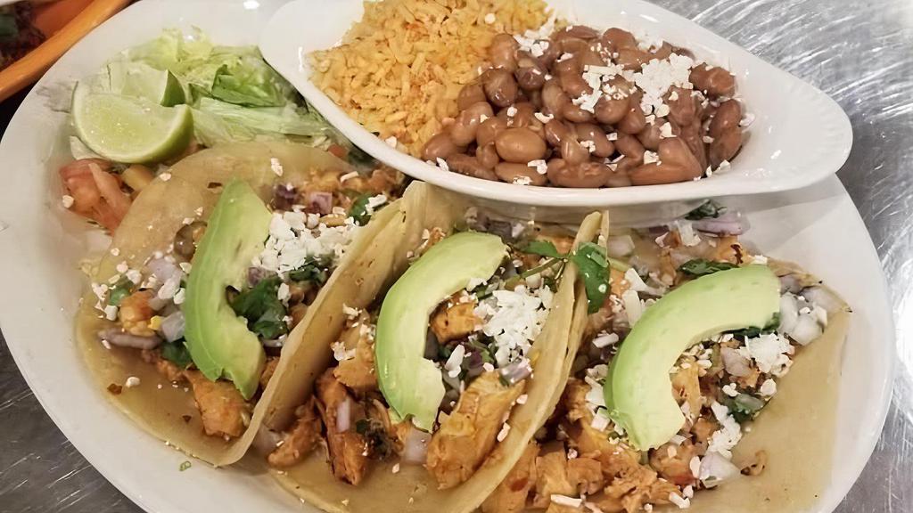 Street Tacos · Three corn tortillas with your choice of chicken or carnitas served street-style with red onion, chopped cilantro, cotija cheese and diced avocado. Served with rice and pinto beans. Add Steak for an additional charge.