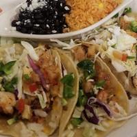 Shrimp Tacos · Three corn tortillas filled with grilled lime shrimp, topped with a pineapple chipotle slaw,...