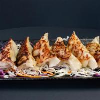 Gyoza · Japanese style pan-fried potstickers filled with seasoned meat and vegetables.