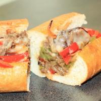 Philly Steak · Seasoned steak, provolone cheese, sautéed onions, and peppers on an artisan sub roll.