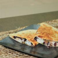 Black Bean Quesadilla · Black beans, shredded cheddar, cilantro-lime rice, sautéed onions, and peppers grilled in a ...