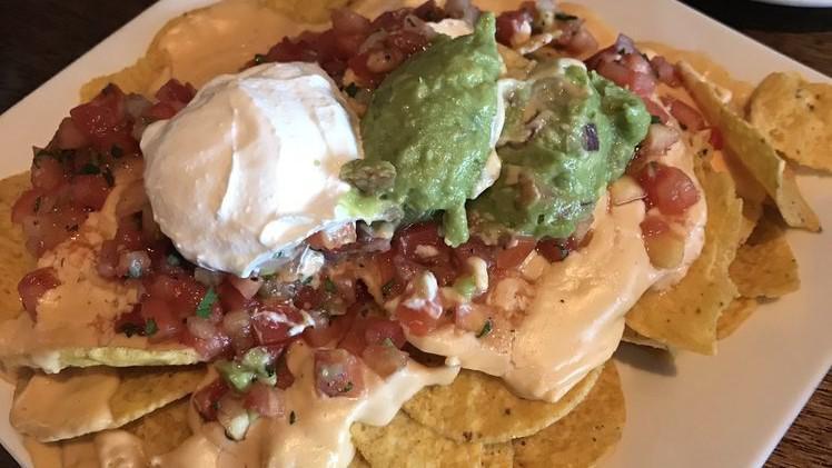 Nachos · Chips, queso, pico de gallo, sour cream, guacamole, pickled jalapeños. Add chicken, steak, carnitas for an additional charge.