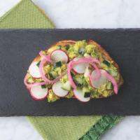 Crunchy Veggie Avocado Toast · Sourdough bread topped with lightly mashed and seasoned avocado, cucumbers, radishes, and pi...