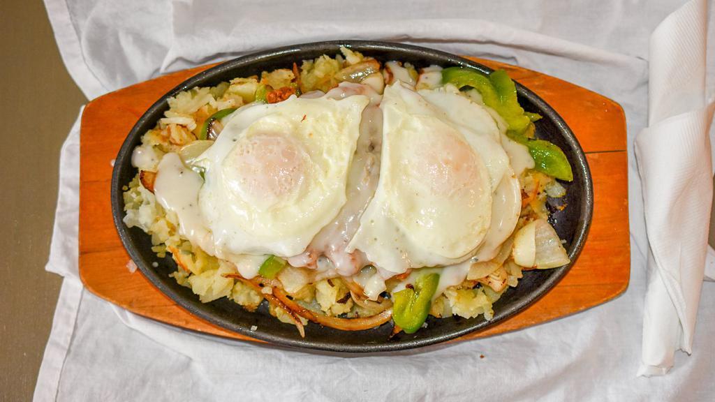 Country Skillet · Chopped chicken fried chicken, onions, green peppers, and smothered in country gravy with two eggs.