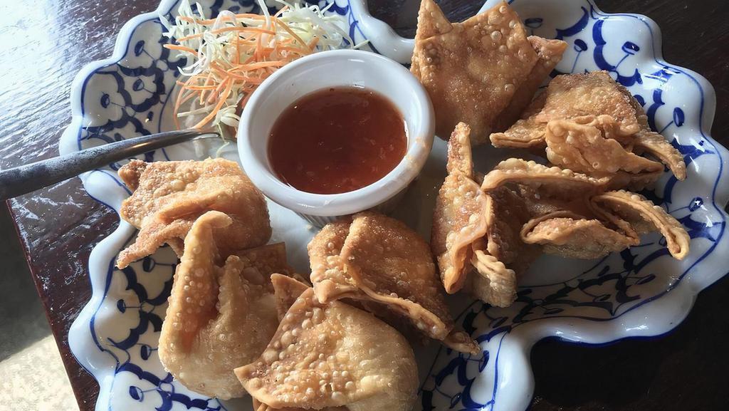 Crab Wontons (7 Pcs) · Deep-fried stuffed crab meat and cream cheese in a thin wonton wrapper and served with sauce.
