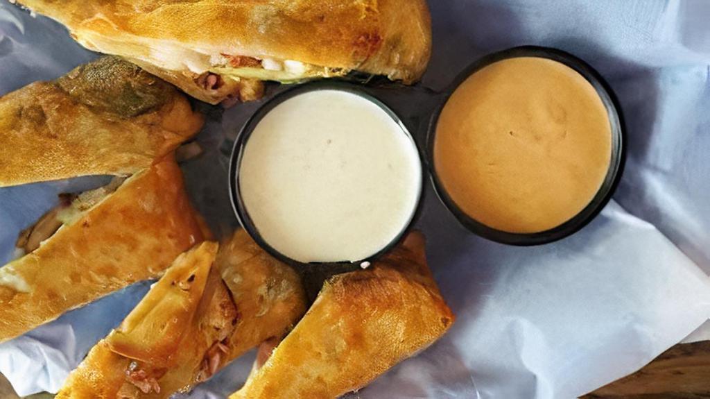 31 East Avocado Rolls · House-made eggrolls filled with chicken, bacon, black beans, avocado, tomato, and cheddar jack cheese, served with jalapeno ranch or chipotle ranch.