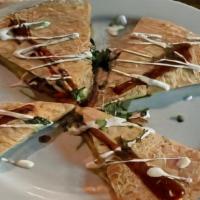 Quesadilla · Grilled Chipotle tortilla stuffed with cheddar jack cheese, black beans, onion, and tomato, ...