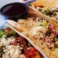Blackened Salmon Tacos · Blackened salmon served in 3 warm flour tortillas, topped with chipotle aioli, coleslaw, gre...