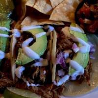 Carnitas Street Tacos · Marinated shredded pork served in 3 tortillas topped with diced onion, cilantro, avocado, an...