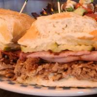 Cuban Pork Sandwich · Gluten-free. Marinated shredded pork with grilled ham, swiss cheese, and pickles, with roast...