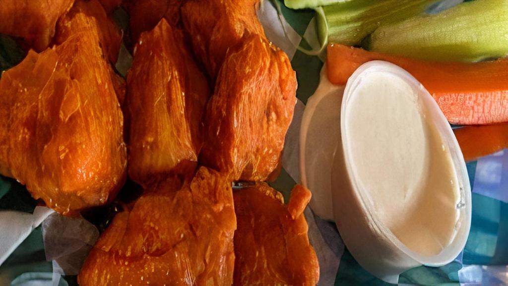 Vegan Tiger Wings · Ten vegan wings tossed in your choice of traditional buffalo hot sauce honey sriracha sauce or house BBQ sauce served with carrots celery and vegan ranch or vegan bleu choose dressing.
