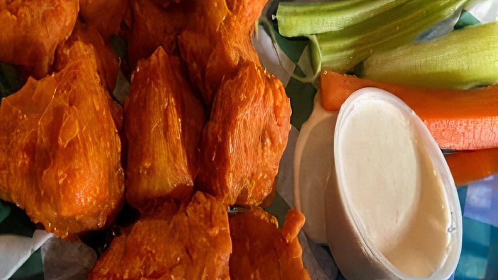 Half Vegan Tiger Wings · Ten vegan wings tossed in your choice of traditional buffalo hot sauce honey sriracha sauce or house BBQ sauce served with carrots celery and vegan ranch or vegan bleu choose dressing.