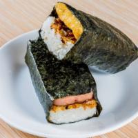 Spam Musubi · Wrapped in a sheet of nori with a layer of rice, sesame seeds, fried crispy onions and a swe...