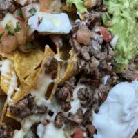 Super Nachos · Homemade corn chips with refried beans, our pico de gallo, Monterey jack cheese topped with ...