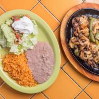 Fajitas (Chicken, Beef Or Combination) · served with rice, refried beans, salad, guacamole, sour cream and tortillas. fajitas are pre...